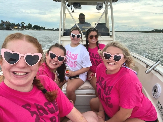 Bachelorette party group taking a selfie on a private boat tour in Hilton Head